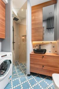 y baño con lavabo y lavadora. en Apartament Plac Konstytucji by Your Freedom, en Varsovia