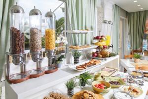 a buffet of food and pastries on display at Klonos Anna in Egina