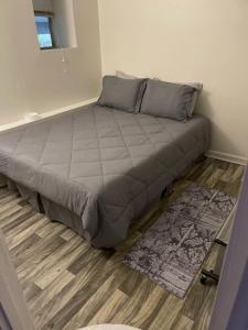 a large bed in a bedroom with a wooden floor at The Van Zant House in Jacksonville