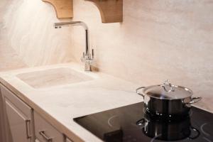 a pot sitting on a stove in a kitchen at Zefiro Apartments in San Vincenzo