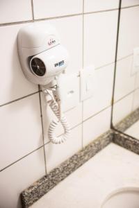 a security camera on a wall in a bathroom at Hotel Continental Business - 200 metros do Complexo Hospitalar Santa Casa in Porto Alegre