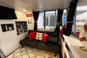 a living room with a couch in a trailer at Seagull Bungalow in the Harbor in Savanna