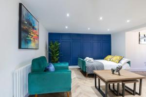 a living room with a bed and a couch and a table at Prestbury Road in Cheltenham