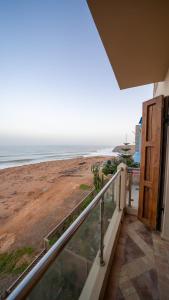 a balcony with a view of the beach at Dar diafa samira in Mirleft