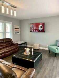 a living room with a couch and a table at The Horseshoe Falls Villa in Niagara Falls