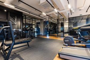 a gym with treadmills and cardio equipment in a room at Dream Apartment Portova Gdynia in Gdynia