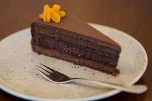 a piece of chocolate cake on a plate with a fork at Penzión Familia in Poprad