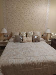 a bedroom with a large bed with two lamps at Hotel Sanremo in Sanremo