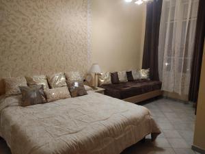 a bedroom with a large bed and a couch at Hotel Sanremo in Sanremo