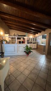 a large kitchen with white cabinets and a tile floor at Borgo di Santa Barbara in Santa Domenica