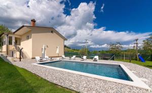 basen z krzesłami i dom w obiekcie Villa Butoniga Nature w mieście Buzet
