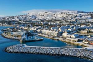 an aerial view of a harbor with a city at Cosy one bed apartment in Carnlough in Ballymena