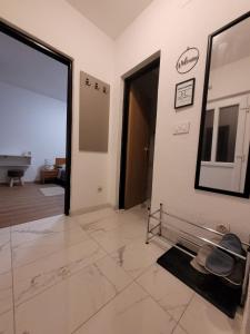 a room with a hallway with a mirror and a door at Kod Dide - entry with pin 0-24h in Slavonski Brod