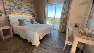 a bedroom with a bed and a large window at Borgo di Santa Barbara in Santa Domenica