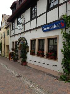 a building with a clock on the side of a street at Marktschänke in Bad Dürkheim