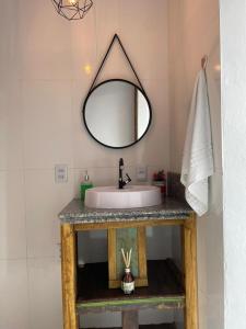 a bathroom with a sink and a mirror at Entre serra pousada de altitudes in Urubici +39 photos