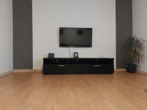a flat screen tv sitting on top of a dresser at Venos rooms in Hirtshals