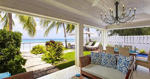 a screened in porch with a view of the ocean at Radwood 2 by Barbados Sothebys International Realty in Saint James