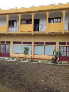 a yellow building with a lot of windows at Holiday Homes in Nazaré