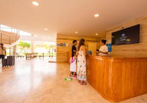 a group of people standing at a counter in a lobby at Bella Terra Laguna Azul Resort & Spa in Sauce