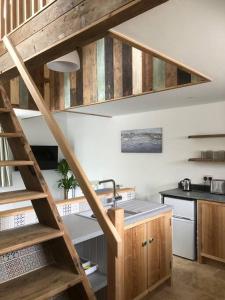 a kitchen with wooden stairs and a kitchen sink at Cosy Rustic Annex in quiet Cornwall Village in Saint Wenn