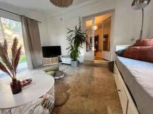 a living room with a couch and a table at Maison provençale au calme de la campagne avec Jacuzzi in Aix-en-Provence