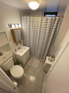 a bathroom with a toilet and a sink and a shower at Fantastic stay for 4 – Heart of Hoboken! in Hoboken