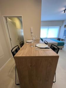 a large wooden island in a room with chairs at Departamento Rivadavia in Mar del Plata