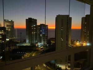 a view of a city at night from a building at Costa de Montemar in Concón
