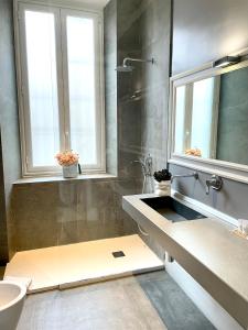 a bathroom with a sink and a shower at XENIA LUXURY ROOMS in Reggio di Calabria