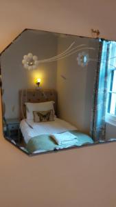 a mirror reflection of a bed in a bedroom at Laston House in Ilfracombe