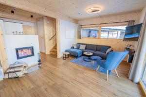 a living room with a couch and a fireplace at Chalet Bavaria in Sankt Lorenzen ob Murau