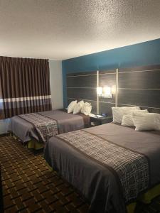 a hotel room with two beds in a room at Faribault Hometown Inn & Suites in Faribault