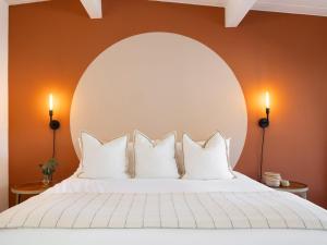 a bedroom with a large white bed with an arch above it at Laguna Beach Lodge in Laguna Beach