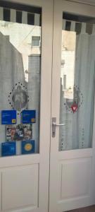 a white door with a sticker on the window at Il Risveglio nei Sassi in Matera