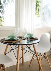 a dining room table with two plates and glasses on it at Laguna Beach Lodge in Laguna Beach