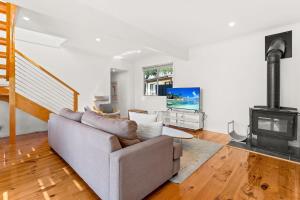 a living room with a couch and a fireplace at Sea to Sunset View in Ventnor