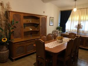 a dining room with a table and a cabinet at Recanto Arlecchino in Águas de Lindóia