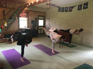 a group of people doing yoga in a room at Sewall House Yoga Retreat in Island Falls