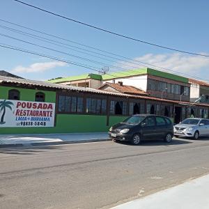 a car parked on the street in front of a building at Pousada Lagoa de Araruama in Araruama