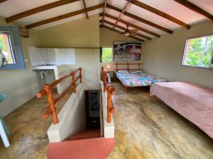 a room with two beds and a staircase at YES PAPA! Rooms at 100m from the beach! in Las Galeras