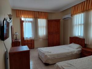 Postel nebo postele na pokoji v ubytování Yeşilkaya Hotel