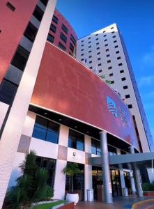 a building with a sign on the front of it at Iate Plaza Flat 613 in Fortaleza