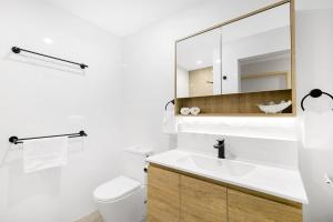 a bathroom with a sink and a mirror at Tiarri Terrigal in Terrigal