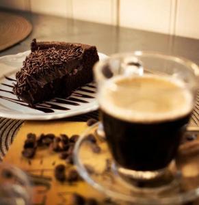 a piece of chocolate cake and a cup of coffee at Jardim Urbano Cambará do Sul in Cambara do Sul