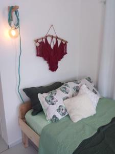 a bedroom with a bed with pillows and a lamp at Jardim Urbano Cambará do Sul in Cambara do Sul