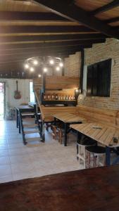 una sala da pranzo con tavoli in legno e TV di Lago 7 Cores a Tapiraí