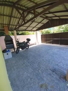 a motorcycle parked in a parking lot at Tiny House Perfeita para Casais in Florianópolis