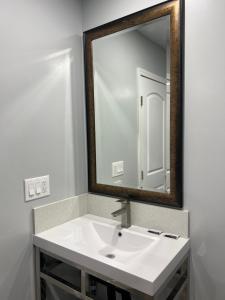 a bathroom with a white sink and a mirror at Pine tree inn in Los Angeles