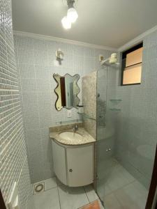 a bathroom with a sink and a shower at Atlântico Flat -207- Vista ao Mar e Pé na Areia in Natal